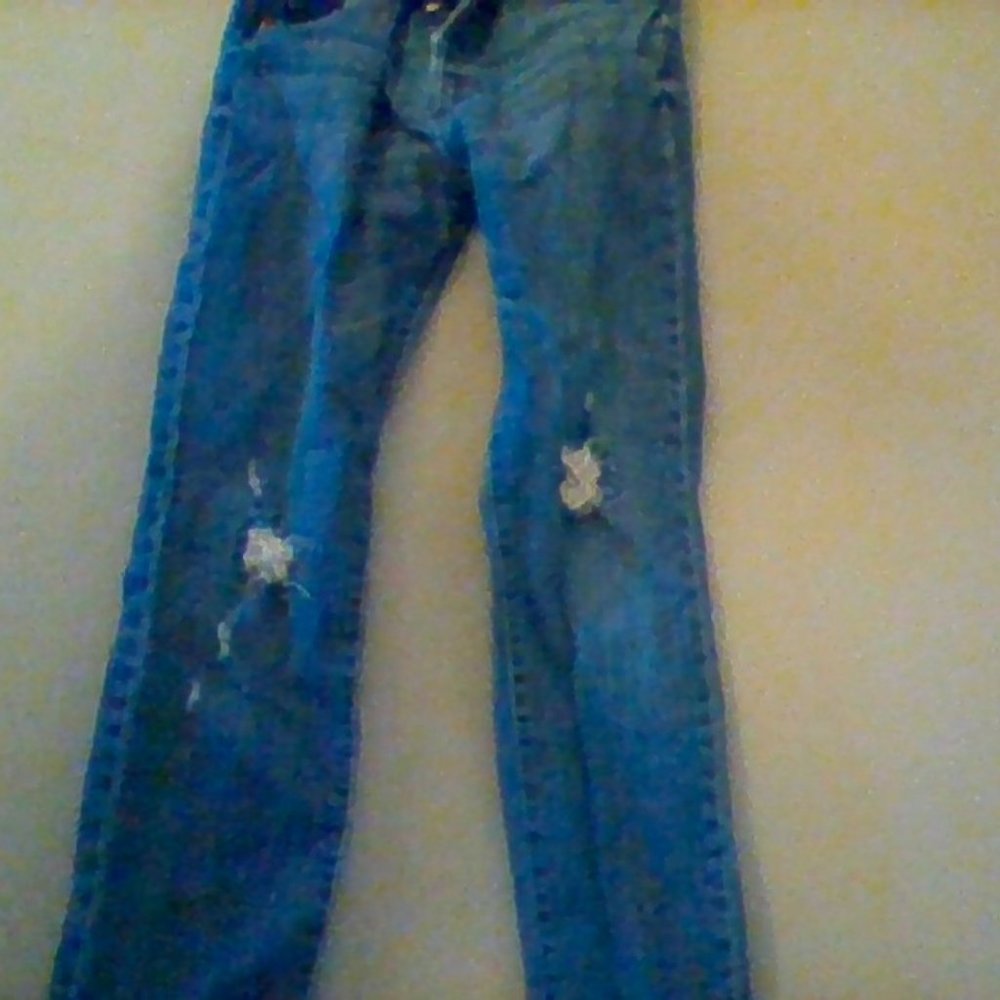 blue back covered ripped open bottom jeans